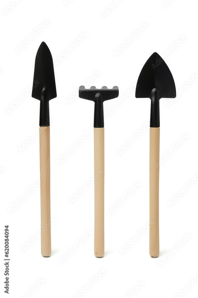 Close-up shot of a mini garden tool set consisting of a trowel, a shovel, and a rake. Small gardening tools with wooden handles are isolated on a white background. Top view. Close-up shot of a mini garden tool set consisting of a trowel, a shovel, and a rake. Small gardening tools with wooden handles are isolated on a white background. Top view.