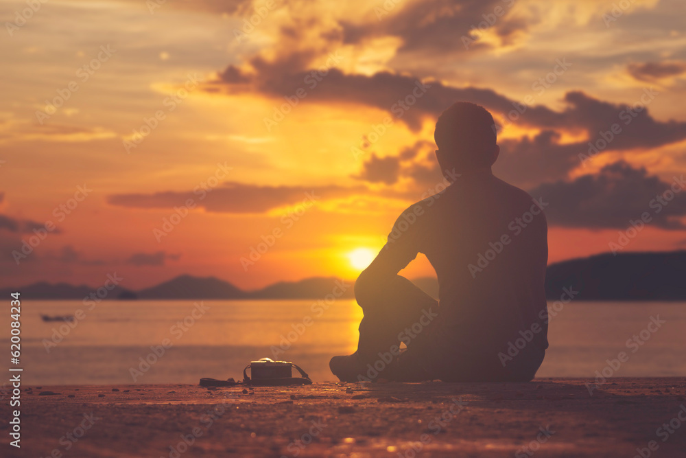 photographer sitting and sea sunset
