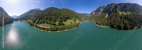 360 degrees panorama of Lac Montriond seen from above. Aerial of French Alps mountain range melt water lake in summer. photo