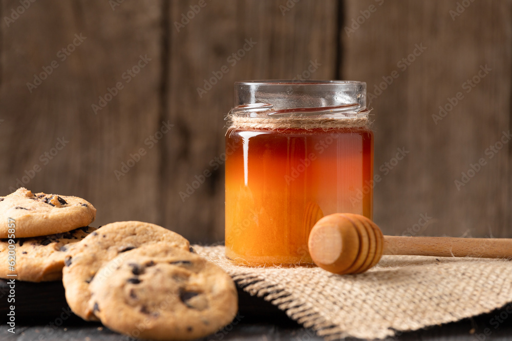 Honey and homemade cookies on a wooden background Honey and homemade cookies on a wooden background