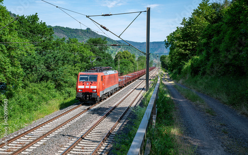 a train of the Deutsche Bundesbahn drives through the German green landscape