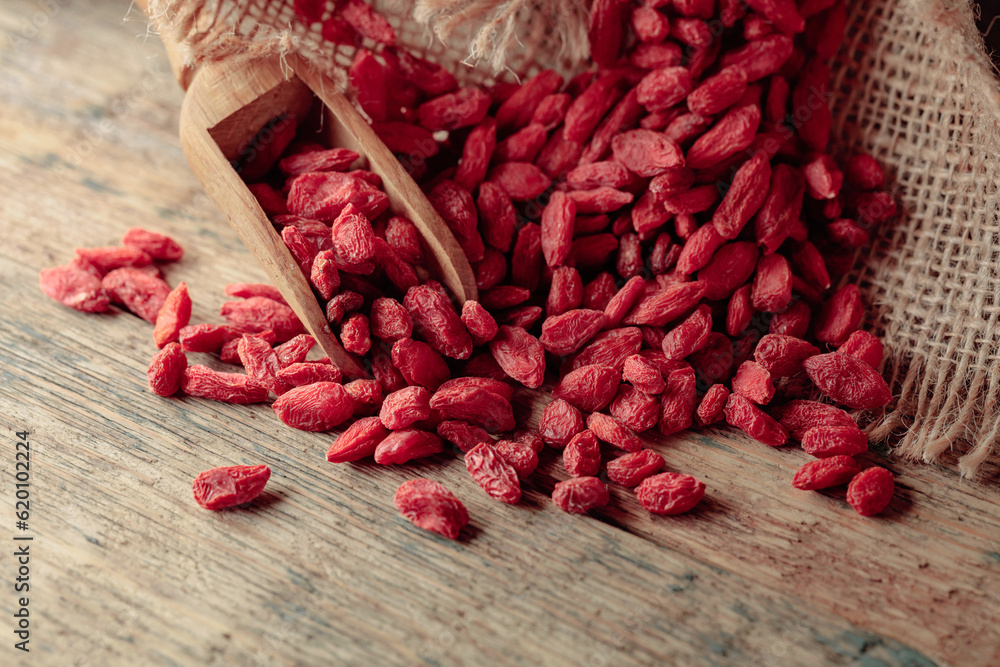 Dried goji berries on a wooden table. Dried goji berries on a wooden table.
