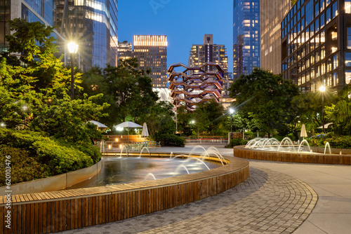 Fototapeta Naklejka Na Ścianę i Meble -  Park and fountains at Hudson Yards building complex in evening. Summer in Midtown West, Manhattan, New York City