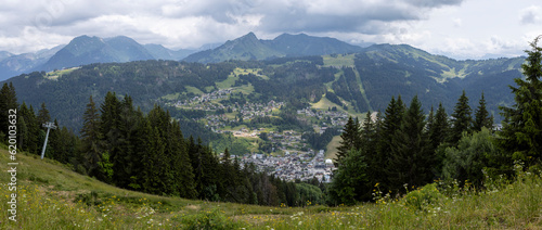 Valley of tourist town Les Gets outdoor sports holiday destination surrounded by the green French Alps seen from the top of the Belvedere mountain