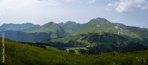 Wide panorama view from the top of Belvedere showing green slopes of Alpine lanscape with French Alps during summer. Outdoor mountainous sports. 