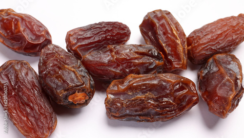 Dry ripe sweet date fruit on white background