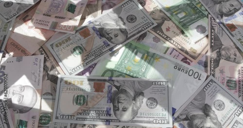 Money dollars hryvnia euro rotate with pyramidal illumination