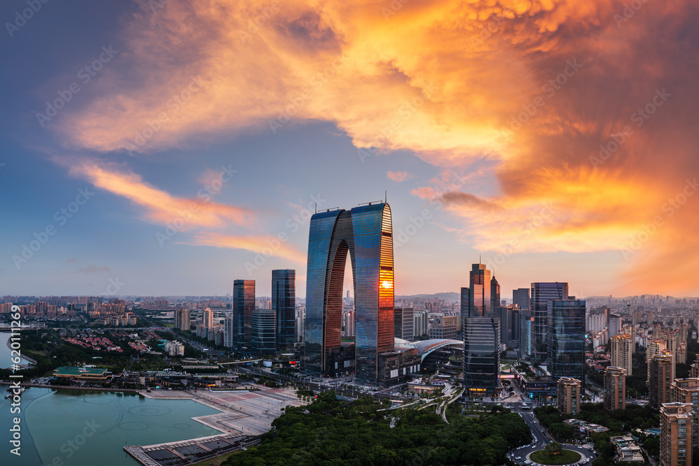 Aerial view of city skyline and modern buildings in Suzhou at sunset, Jiangsu Province, China.