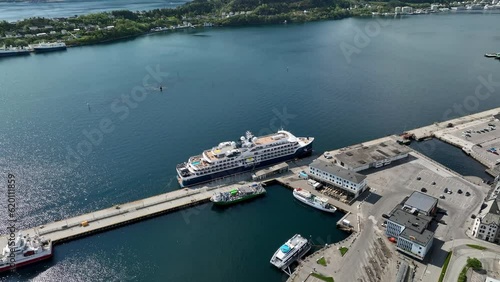 Luxury Cruise Ship SH Helena alongisde port of Aalesund in Norway at sunny summer day - Aerial photo