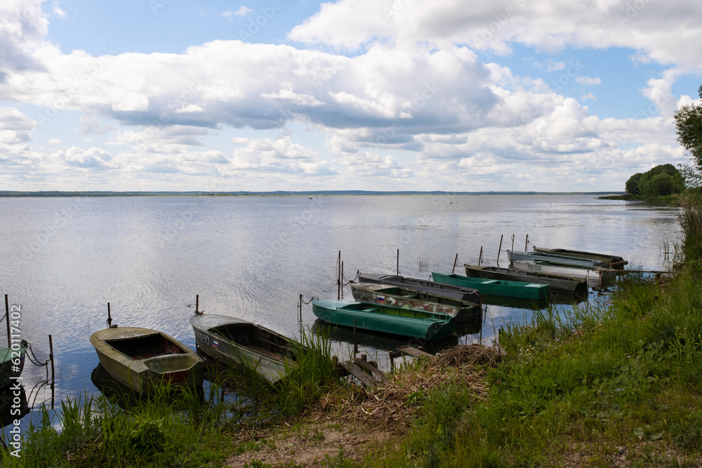 Rostov, Russia - June 10, 2023. Boats on the shores of Lake Nero. Cloudy weather, beautiful sky.