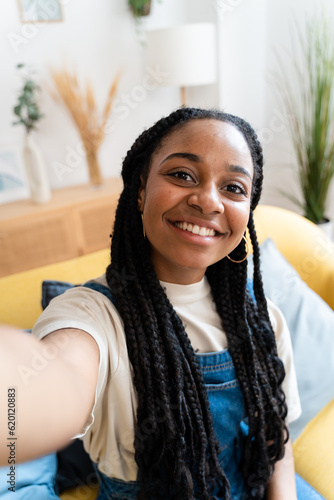 Smiling woman taking selfie from home. photo