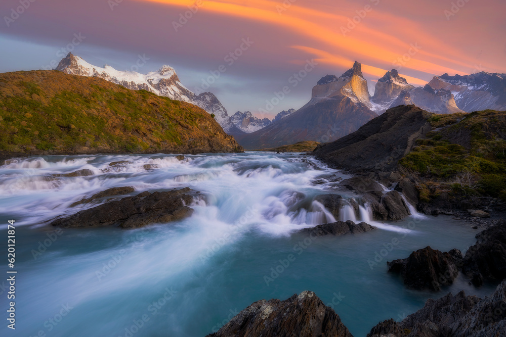 Beautiful Salto Grande Waterfall with mountain view at Torres del Paine National Park, Patagonia in Chile during sunrise time.