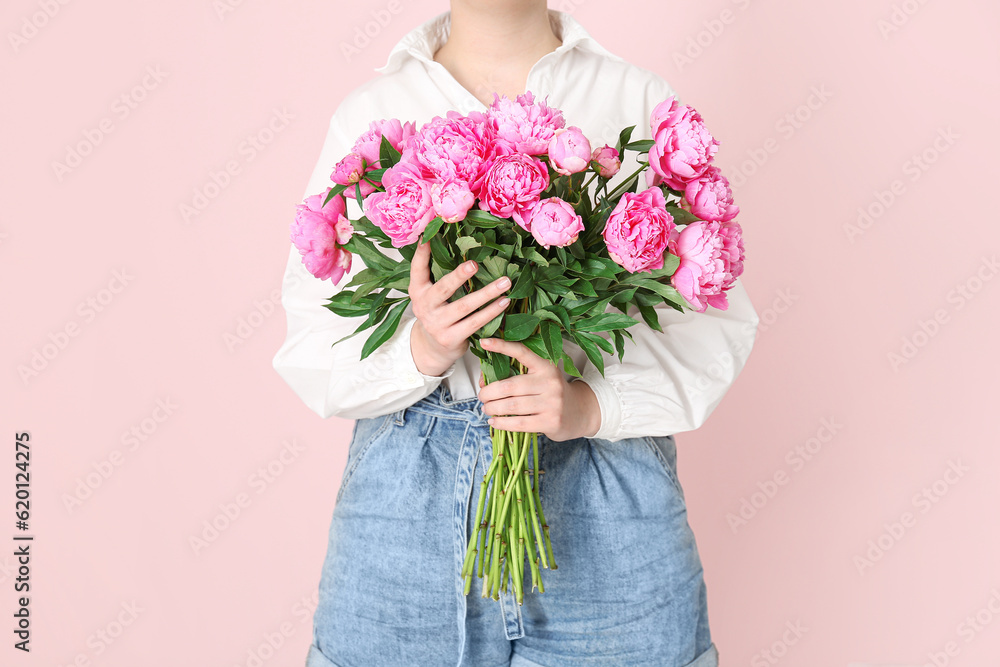 Woman holding bouquet of pink peonies on color background Woman holding bouquet of pink peonies on color background