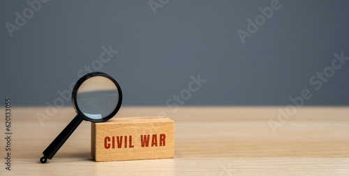Civil war concept. War between organized groups within the same country or state. Control of the region, to achieve independence. Words on a wooden blocks © Andrii Yalanskyi