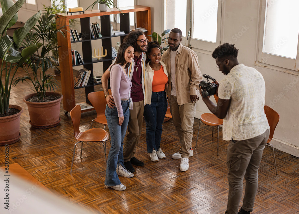 Fototapeta premium group of diverse workers in coworking, they are shooting a promotional video photographer videographer blog