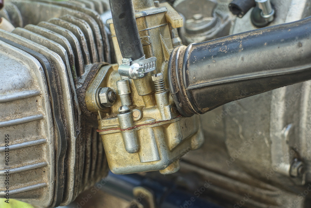 a very old iron dirty in oil retro carburetor k-65 made in the USSR to supply fuel to the engine of an old soviet motorcycle a very old iron dirty in oil retro carburetor k-65 made in the USSR to supply fuel to the engine of an old soviet motorcycle