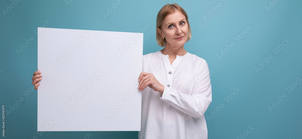 mature woman holding white paper poster with note mockup mature woman holding white paper poster with note mockup