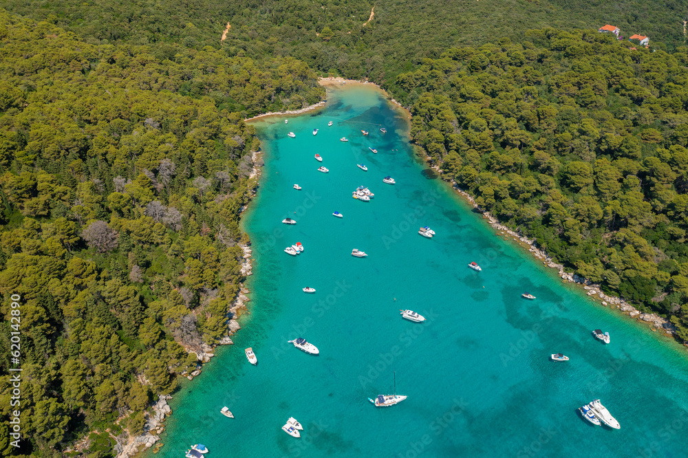Cifutna Bay on Rab Island, Croatia, with a beach and the boats
