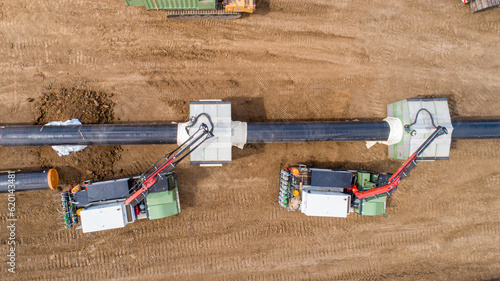 Gas and oil pipeline construction. Pipes welded together. Big pipeline is under construction. Aerial view