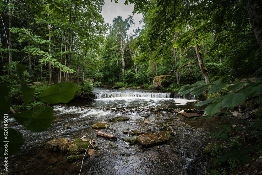 Naklejka premium Small waterfall Nõmmeveski in Estonia on the river Valge.
