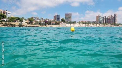 Buoy on the water in the mediterranean sea and view on a Alicante city