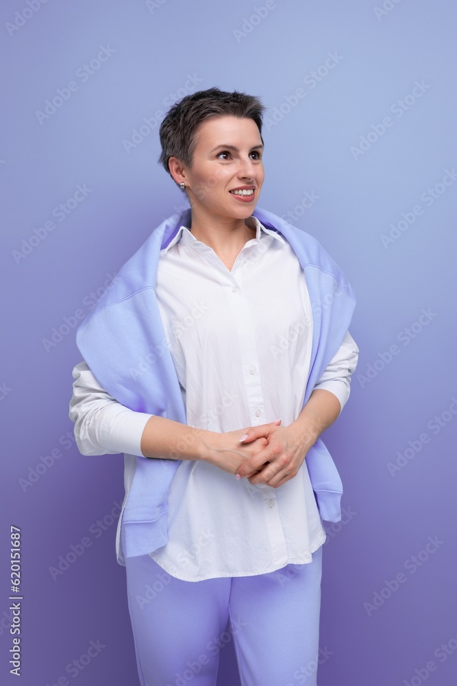 thinking smart young lady with short haircut on purple bright background thinking smart young lady with short haircut on purple bright background