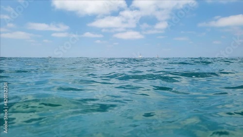 Video filming of the mediterranean sea from a low angle, from the level of the water surface, a view of the horizon
