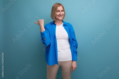 kind cute middle aged woman in casual shirt on blue background