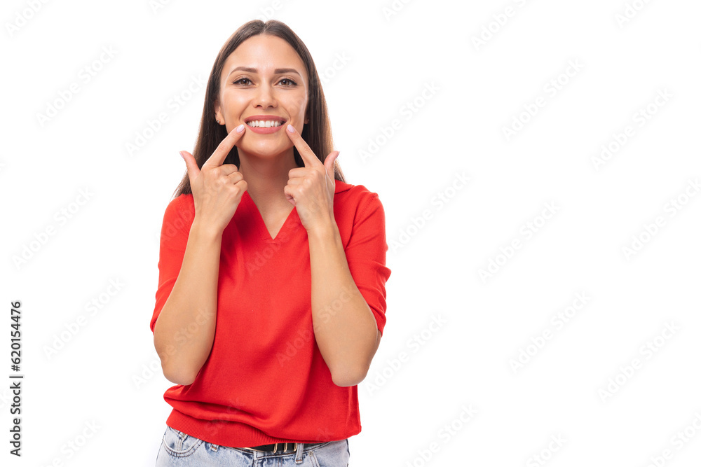 pretty caucasian woman with black hair is wearing a red blouse with a v-neck on a white background with copy space pretty caucasian woman with black hair is wearing a red blouse with a v-neck on a white background with copy space