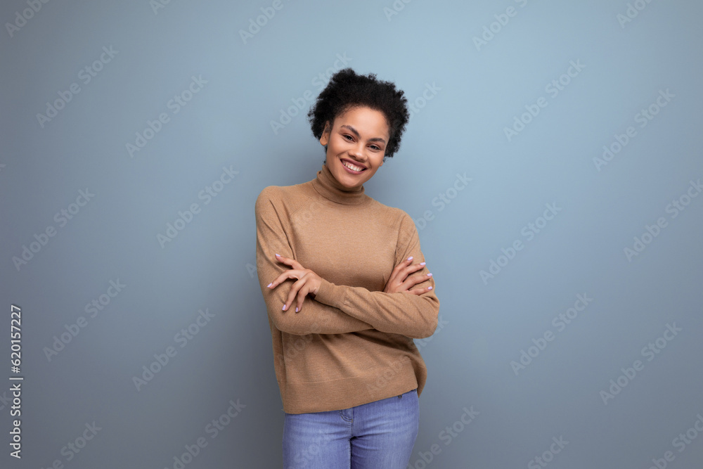 young pretty hispanic lady with afro curly hair in casual clothes posing against background with copy space young pretty hispanic lady with afro curly hair in casual clothes posing against background with copy space