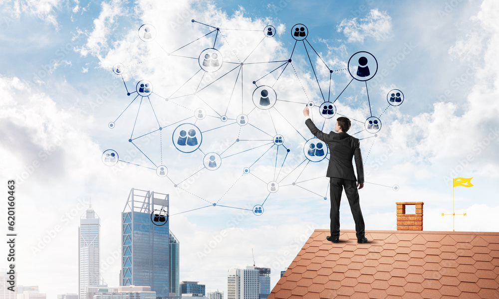 Businessman on house roof presenting networking and connection concept. Mixed media Businessman on house roof presenting networking and connection concept. Mixed media