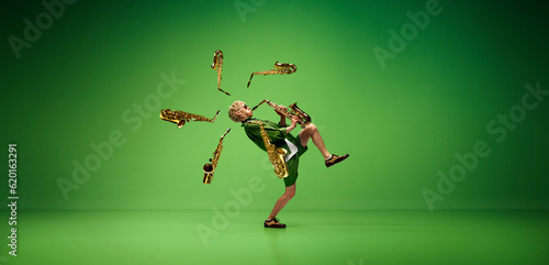 Creative design. Artistic  expressive man emotionally playing saxophone against green studio background. Concept of music  talent  hobby  entertainment  festival  performance  ad