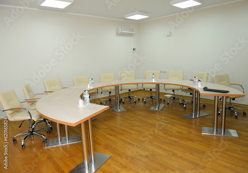 Conference room with a table, chairs and bottles with water put