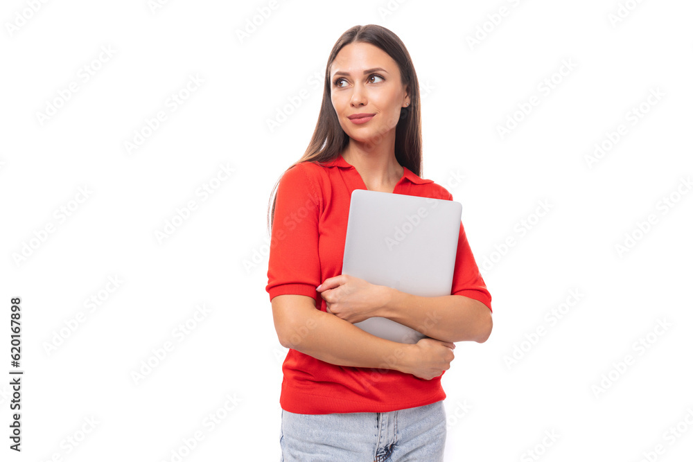 young smiling european woman student with dark straight hair is concentrated on work with holding a laptop in her hands young smiling european woman student with dark straight hair is concentrated on work with holding a laptop in her hands