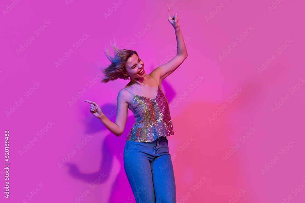 Photo of excited active lady enjoy weekend friday party moving dancing isolated on colorful neon background Photo of excited active lady enjoy weekend friday party moving dancing isolated on colorful neon background