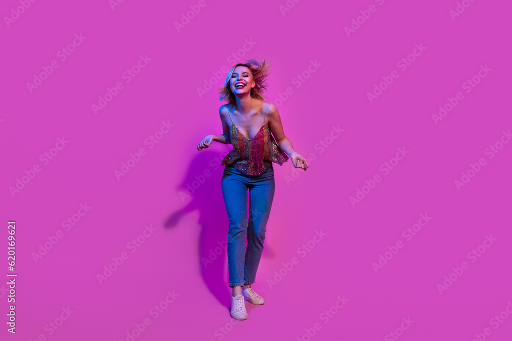 Full body photo of millennial lady dancing hip hop on night club isolated bright neon colorful background Full body photo of millennial lady dancing hip hop on night club isolated bright neon colorful background