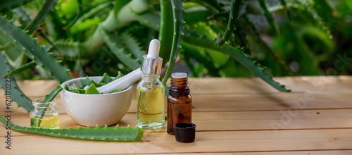 aloe vera essential oil on a wooden background, juice.