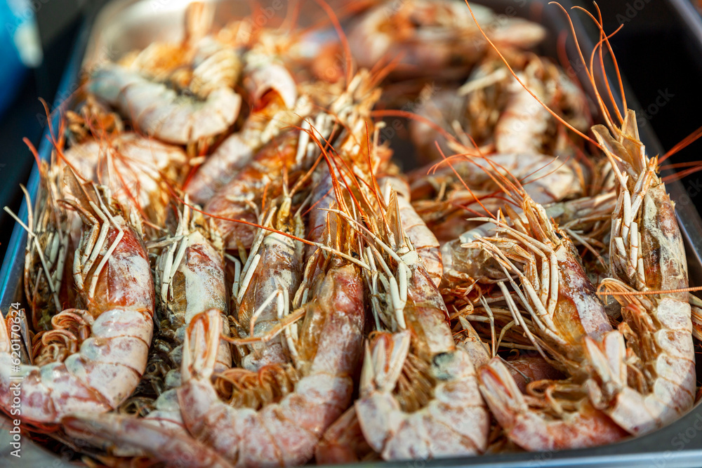 Large shrimp on the counter. Popular and delicious street food. Close-up.