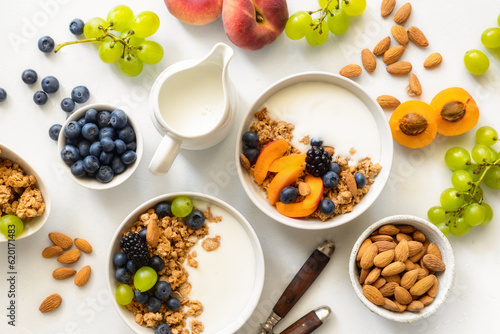 Fotografia Two healthy breakfast bowl with ingredients granola fruits Greek yogurt and berries top view