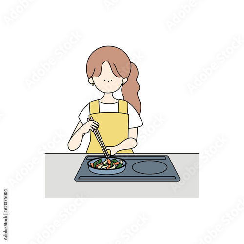 野菜炒めを作る女の子