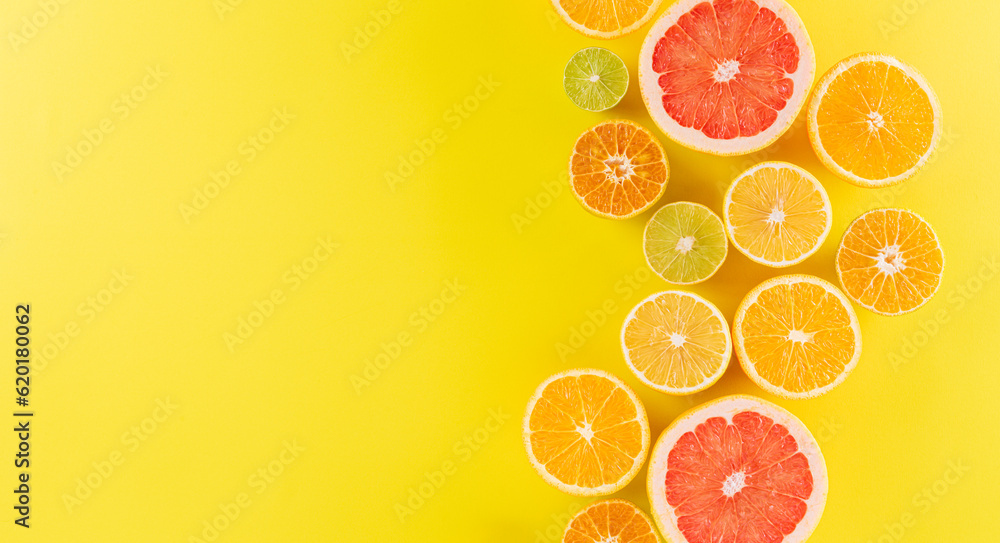Summer composition made from oranges, lemon or lime on pastel yellow background. Fruit minimal concept. Summer composition made from oranges, lemon or lime on pastel yellow background. Fruit minimal concept.