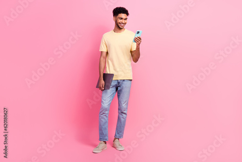 Full body size photo of young it specialist student guy intern using smartphone browsing new job website isolated on pink color background