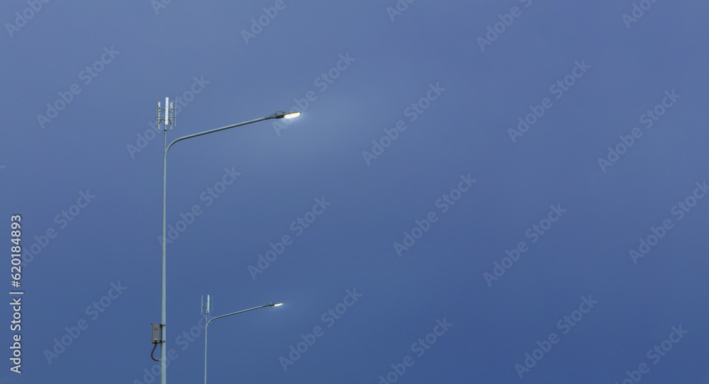 Small wind turbine on street light pole with blue sky background, Lamp post with solar and wind turbine alternative energy for better world concept Small wind turbine on street light pole with blue sky background, Lamp post with solar and wind turbine alternative energy for better world concept