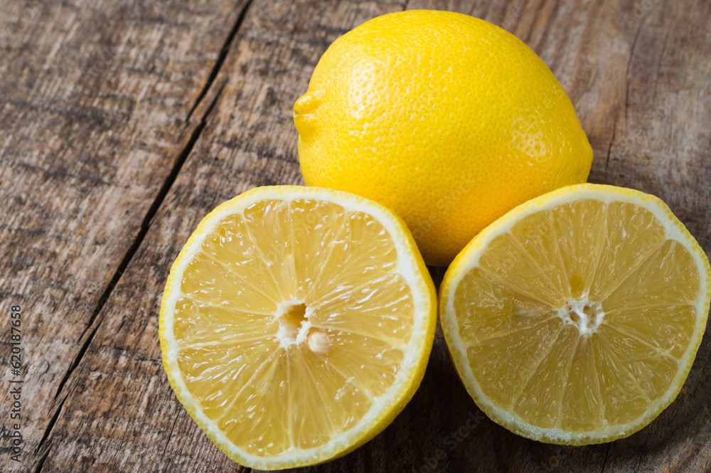 Ripe juicy lemons. Citrus fruits on the wooden background Ripe juicy lemons. Citrus fruits on the wooden background