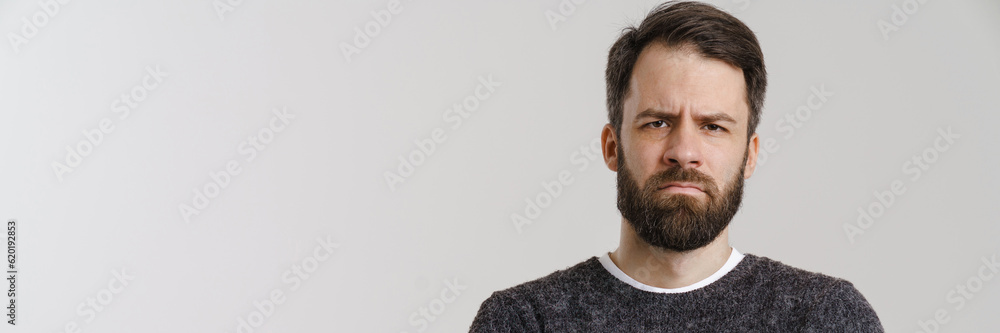 Fototapeta premium White mid man with beard frowning and looking at camera