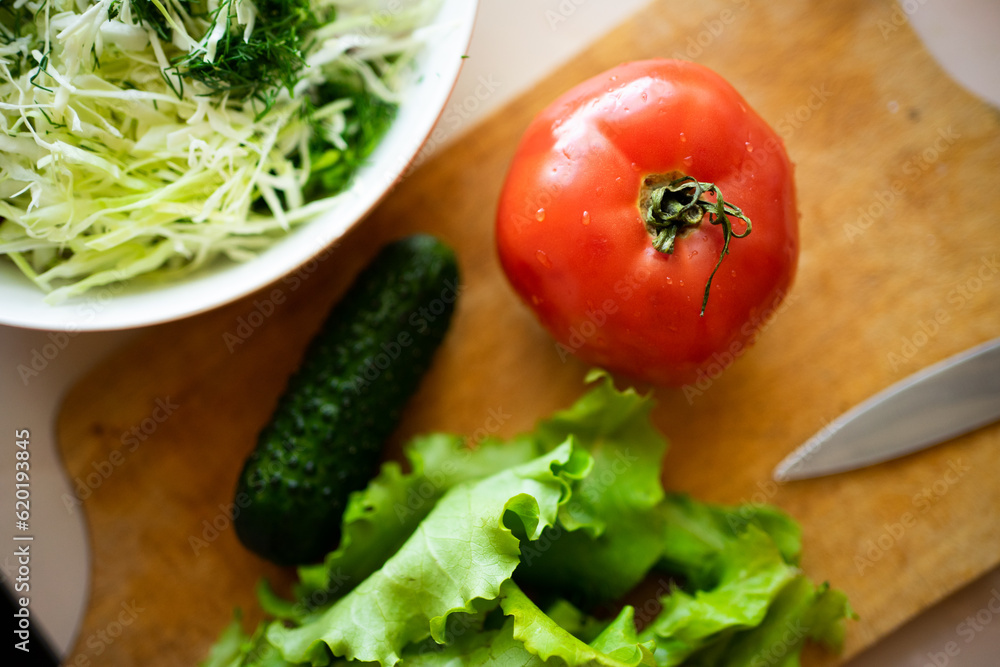 salad, cucumber, posymore and greens on a wooden board. fresh farm products for a healthy lifestyle and diet