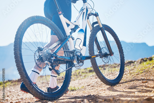 Closeup, outdoor and cyclist with fitness, bike and training for wellness, wheel and performance. Zoom, male person or biker with workout goal, bicycle and athlete with sports, marathon and exercise