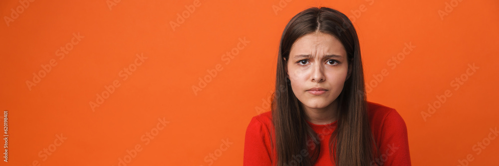 Young white brunette woman frowning and looking at camera Young white brunette woman frowning and looking at camera