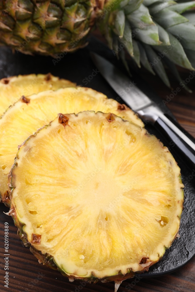 Pieces of tasty ripe pineapple on wooden table, closeup Pieces of tasty ripe pineapple on wooden table, closeup