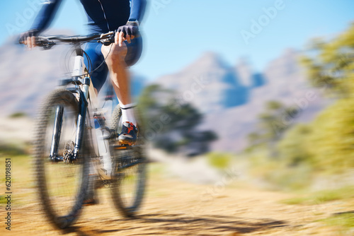 Fototapeta Naklejka Na Ścianę i Meble -  Cycling, fitness and man on a bike in nature for extreme sports, race or training with motion blur. Bicycle, exercise and male cyclist riding on a dirt road with energy, adrenaline or speed challenge